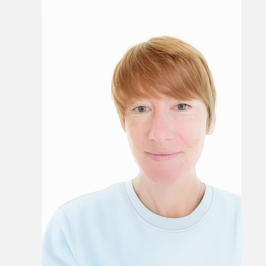 Hayley Wicker-Bradbury, Individual Giving and Legacy Manager at British Wireless for the Blind Fund. She is standing in front of a white wall, smiling, and wearing a light blue top,