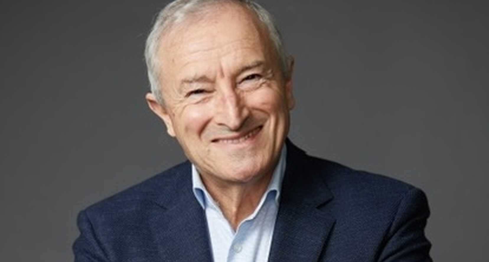 BWBF Patron Jim Rosenthal is wearing a dark suit and light shirt. He is smiling broadly.