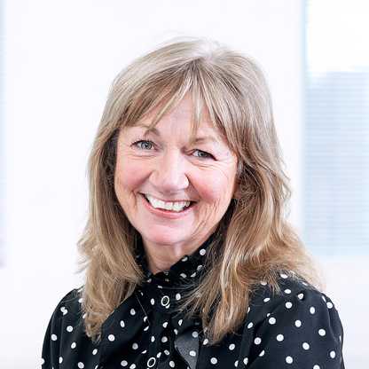 A head and shoulders photograph of BWBF Trustee Lindsey Mack. She is smiling and she is wearing a black blouse with white polka dots.