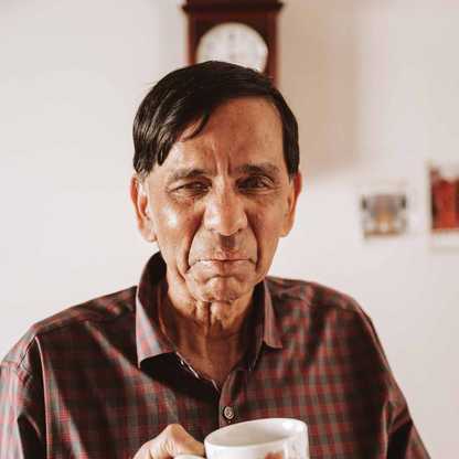 BWBF service user Krishna is in his kitchen with a cup of tea.
