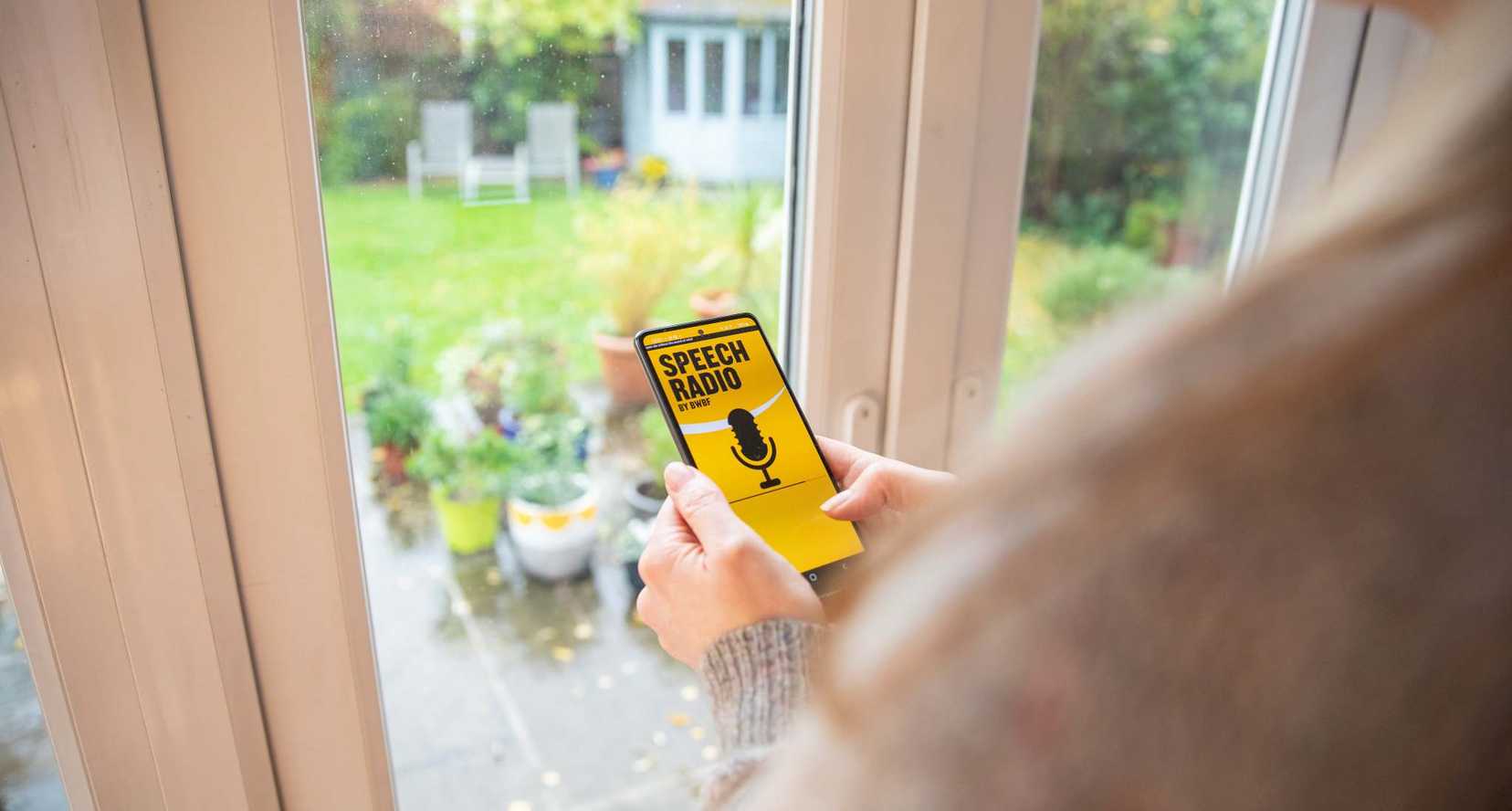 Person using speech radio app on a phone