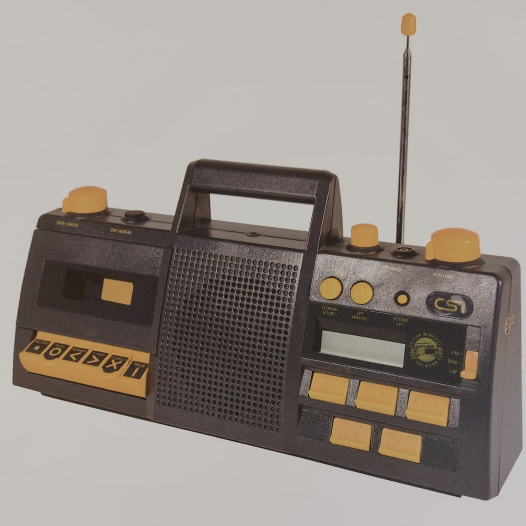 A photo of a Clarke & Smith CS1 1318 radio from the 90s. The radio is black with yellow high contrast controls.