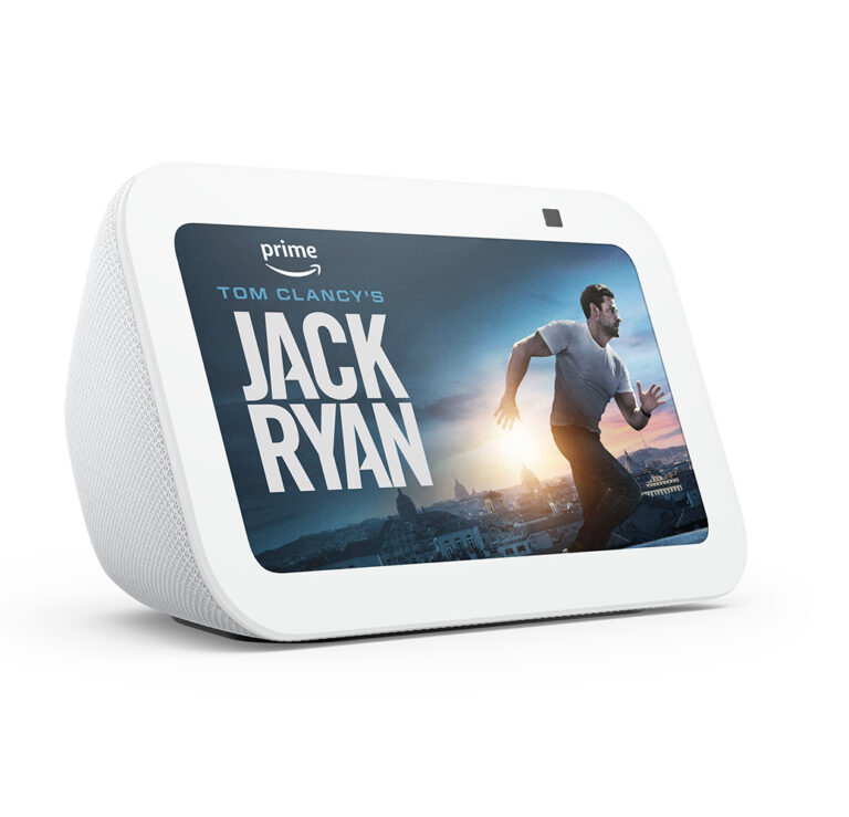 A white, rectangular Amazon Echo Show. The display screen shows a picture of a man running, next to the words Jack Ryan.