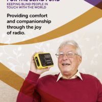 Photo of the cover of BWBF's Impact Report. The cover shows an older man holding a radio and smiling. Text reads: British Wireless for the Blind Fund, Keeping blind people in touch with the world. Underneath, a heading reads: Providing comfort and companionship through the joy of radio. At the top right, text reads: Impact Report 2021. At the bottom text reads: This report is available in other formats.